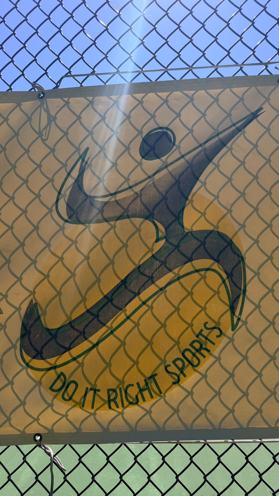 Do It Right Sports logo displayed beside the tennis court