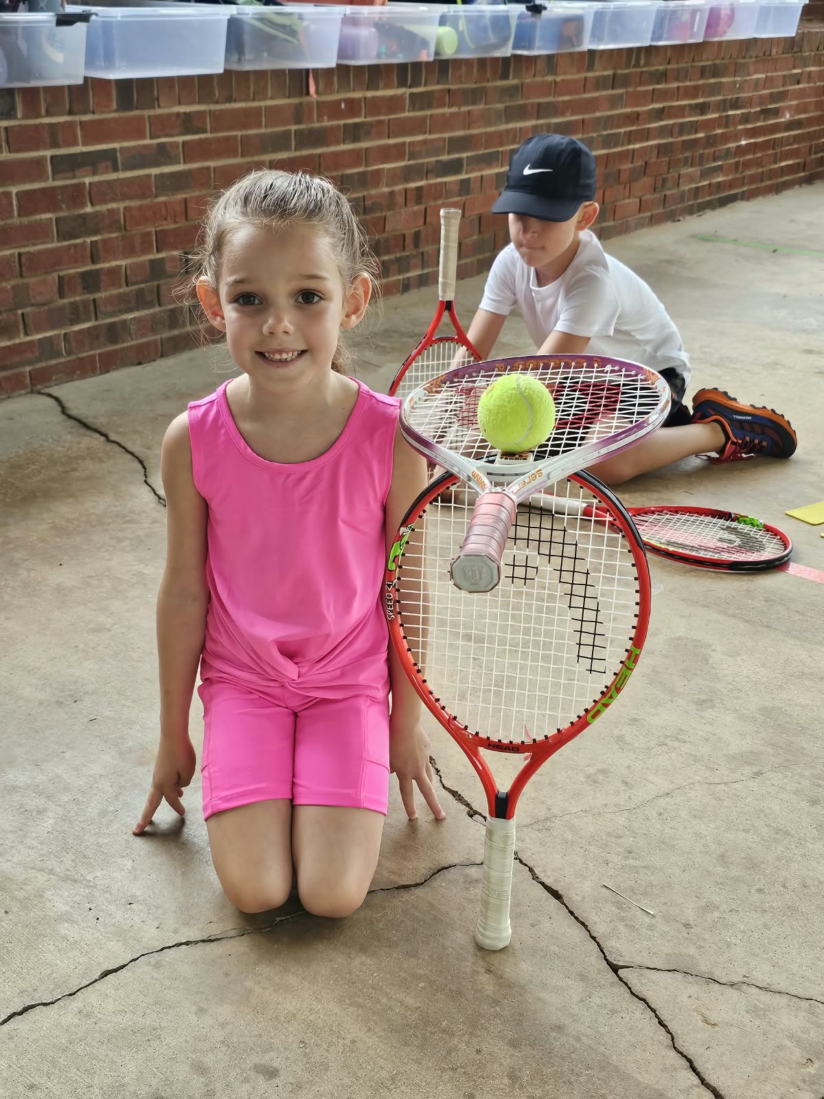 Young tennis students practicing racket and ball control